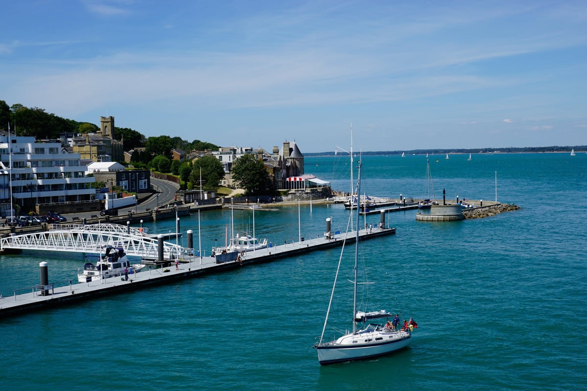 Cowes, Isle of Wight, UK. July 22, 2020. The Royal Yachting headquarters and Royal moorings taken from the Southampton ferry at Cowes on the Isle of Wight